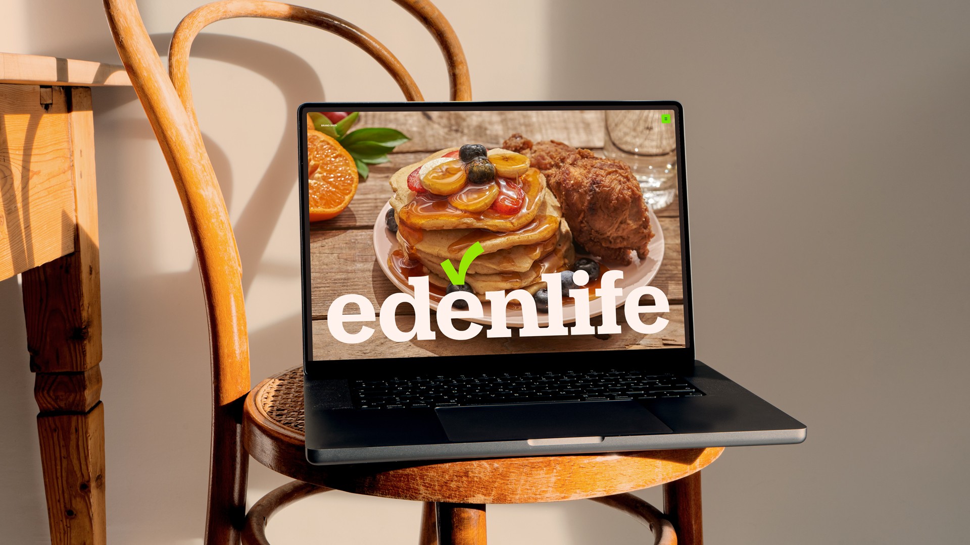 EdenLife website displayed on a laptop with a breakfast photograph