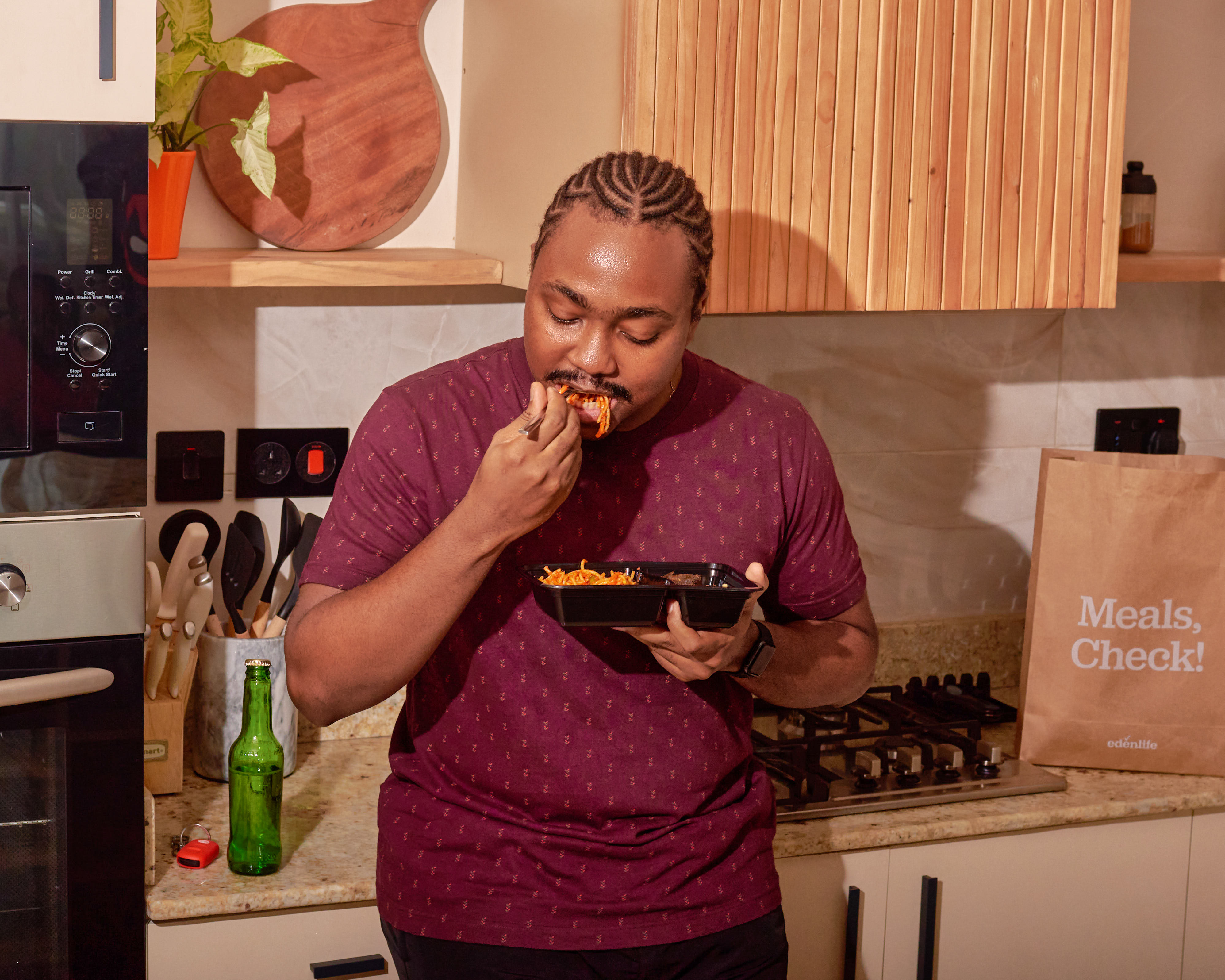 Customer eating a delivered EdenLife meal in his kitchen